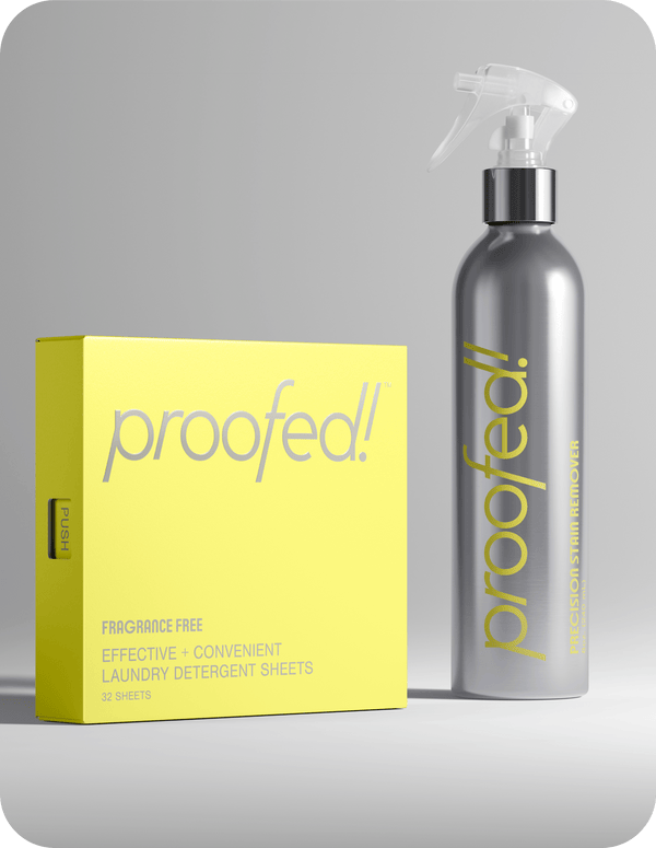 A gray bottle labeled 'PROOFED! Precision Stain Remover' next to a yellow box with 'PROOFED!' and 'FRAGRANCE-FREE EFFECTIVE CONVENIENT LAUNDRY DETERGENT SHEETS' printed on it.